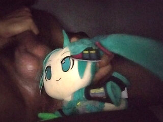 Big guy playing with Hatsune Miku plushie