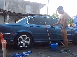 Jesus in gray boxer washing his jaguar car
